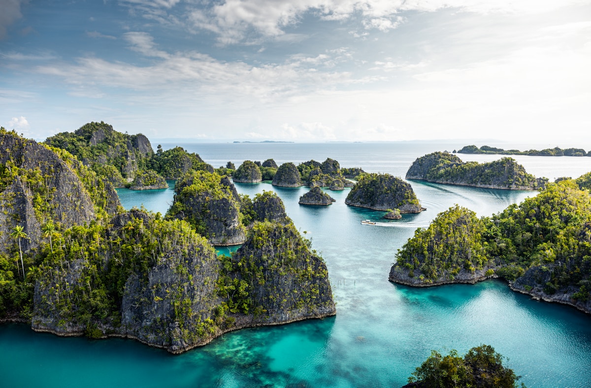 Overwater bungalow on stilts in the turquoise waters of Raja Ampat